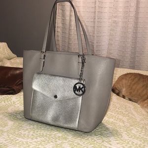 Gray/silver Michael Kors bag with MK keychain